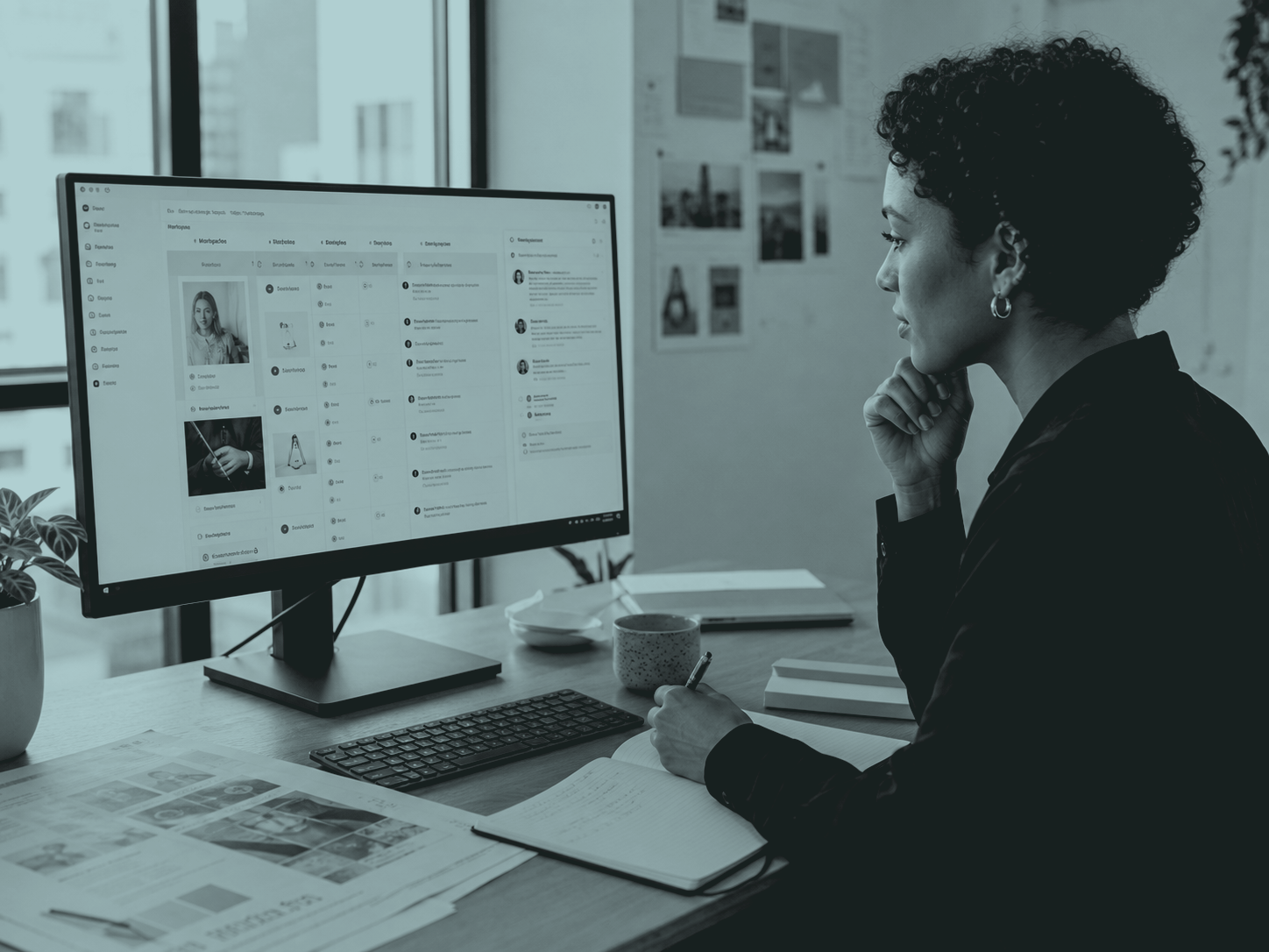 A professional working through a project board on a monitor