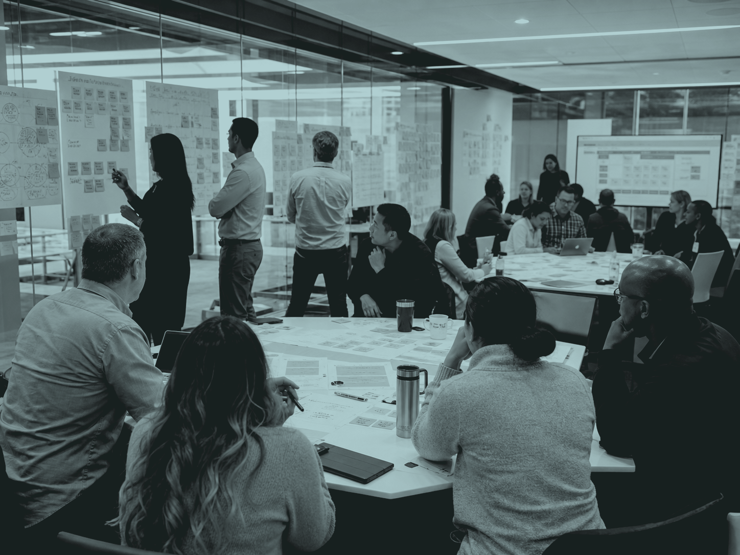 A team testing and mapping a workflow across a wall of notes